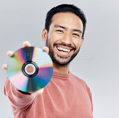 Buy stock photo Happy, showing and portrait of an Asian man with a cd isolated on a white background in a studio. Smile, excited and a Japanese person with a copy of multimedia, music or a movie on a backdrop