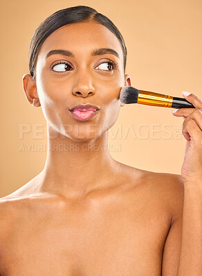 Buy stock photo Indian woman, beauty and brush for makeup with cosmetic tools, skin glow and kiss face on studio background. Happy female, thinking and cosmetology, apply foundation or powder with self care