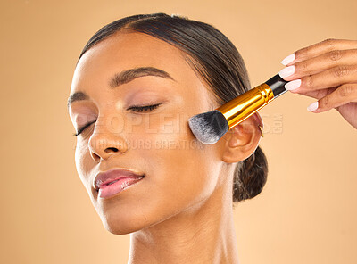 Buy stock photo Indian woman, face and makeup, brush and beauty with cosmetic tools and eyes closed on studio background. Skin glow, cosmetology and apply foundation or powder, cosmetics and peace with self care