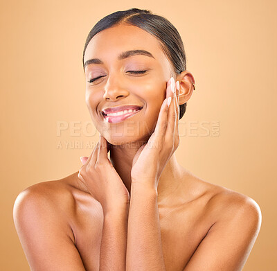 Buy stock photo Beauty, hands on face and skin of woman in studio for happy glow, cosmetics, dermatology or makeup. Aesthetic female smile for self care, natural shine and spa facial results on a brown background
