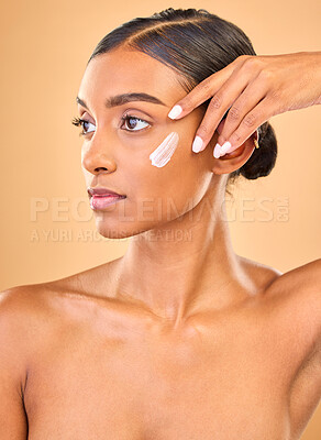 Buy stock photo Face, skincare idea and woman with cream in studio isolated on a brown background. Dermatology, cosmetics and thinking Indian female model with lotion, beauty creme or moisturizer for skin health.