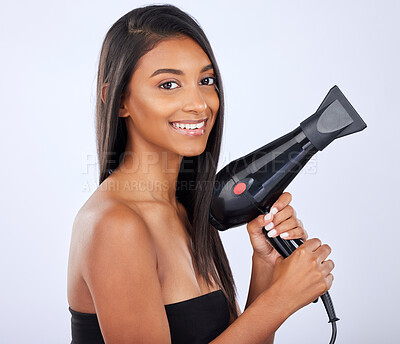 Buy stock photo Happy woman, hair care or dryer in studio portrait for healthy natural shine, beauty or wellness on white background. Face of glowing Indian girl model with salon styling equipment tools in grooming