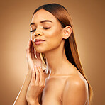 Woman with hand on face, hair and skincare with bronze glow and luxury salon treatment on brown background. Beauty, makeup and skin care cosmetics, hispanic model with straight hairstyle in studio.