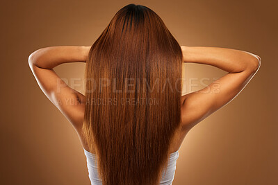 Buy stock photo Back of hair, beauty and woman in studio for growth, wellness and keratin treatment on brown background. Hairdresser mockup, salon and girl with hairstyle for shampoo, haircare texture or cosmetics