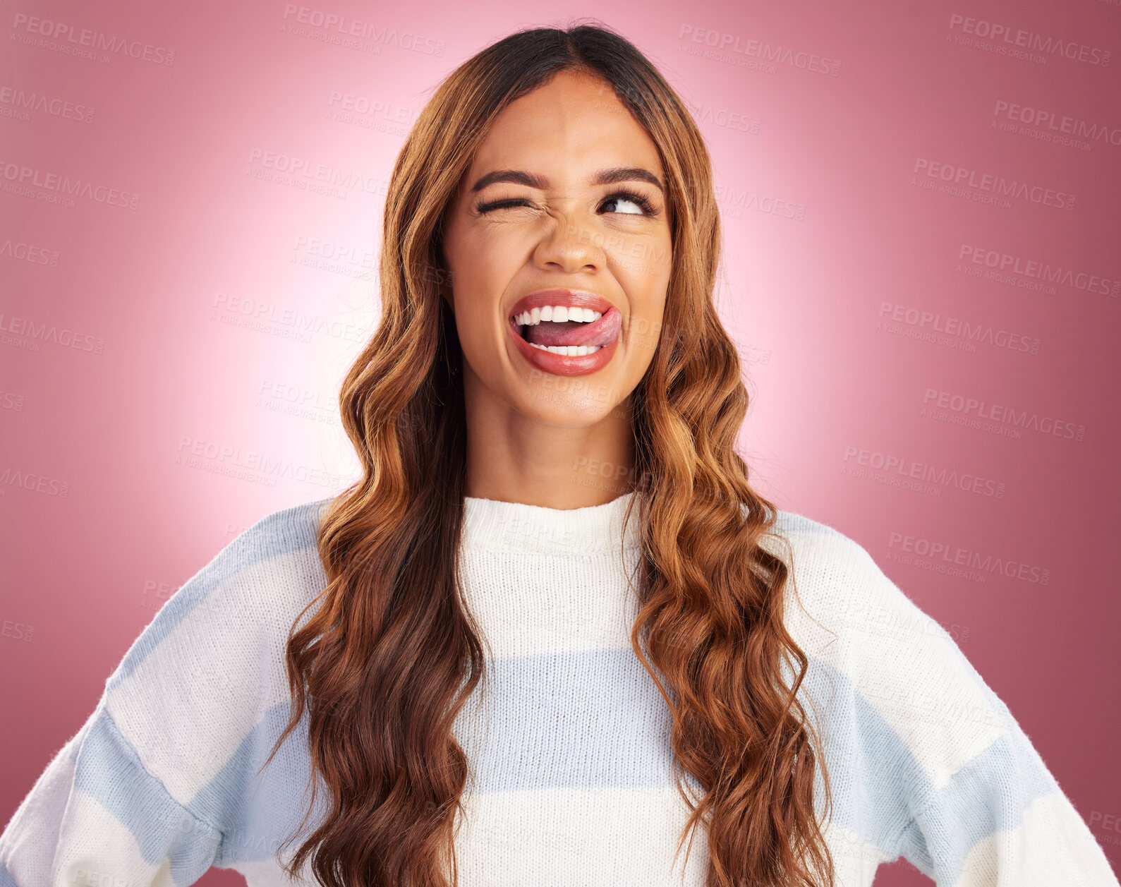 Buy stock photo Funny, face and goofy woman tongue out feeling happy, playful and excited isolated in a studio purple background. Comic, joke and head of a young and crazy female wink for humor or happiness