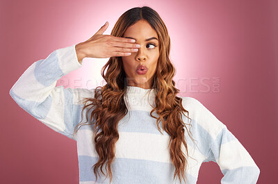 Buy stock photo Funny face, hand gesture and comedy with a woman in studio on a pink background for fun or humor. Eye, comic and crazy with an attractive young female feeling silly, goofy or playful while joking