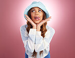 Fashion, tongue out and comic face of woman on studio background for funny, humour and emoji reaction. Beauty, facial expression and happy girl model with trendy hat, cosmetics and confident style