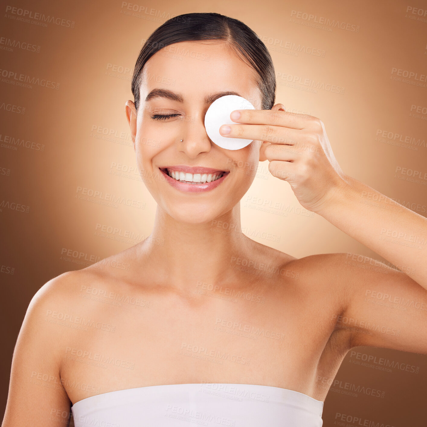 Buy stock photo Skincare, cotton pad and woman eye cleaning of a young person with happiness in a studio. Happy smile and dermatology treatment of a female wiping off cosmetics, wellness and self care facial