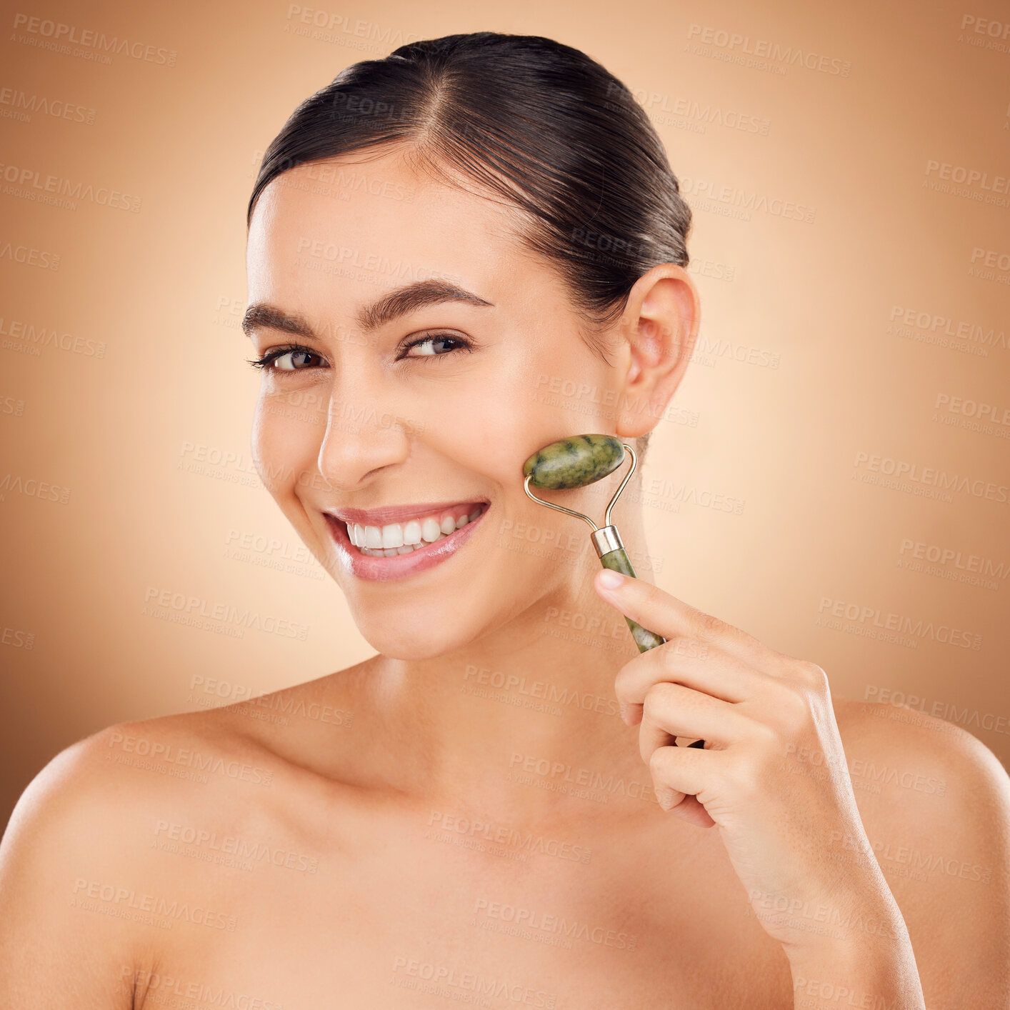 Buy stock photo Skincare, jade roller and portrait of woman in studio for beauty, wellness and anti aging against brown background. Facial, skin and girl relax with massaging tool, facelift and lymphatic drainage 