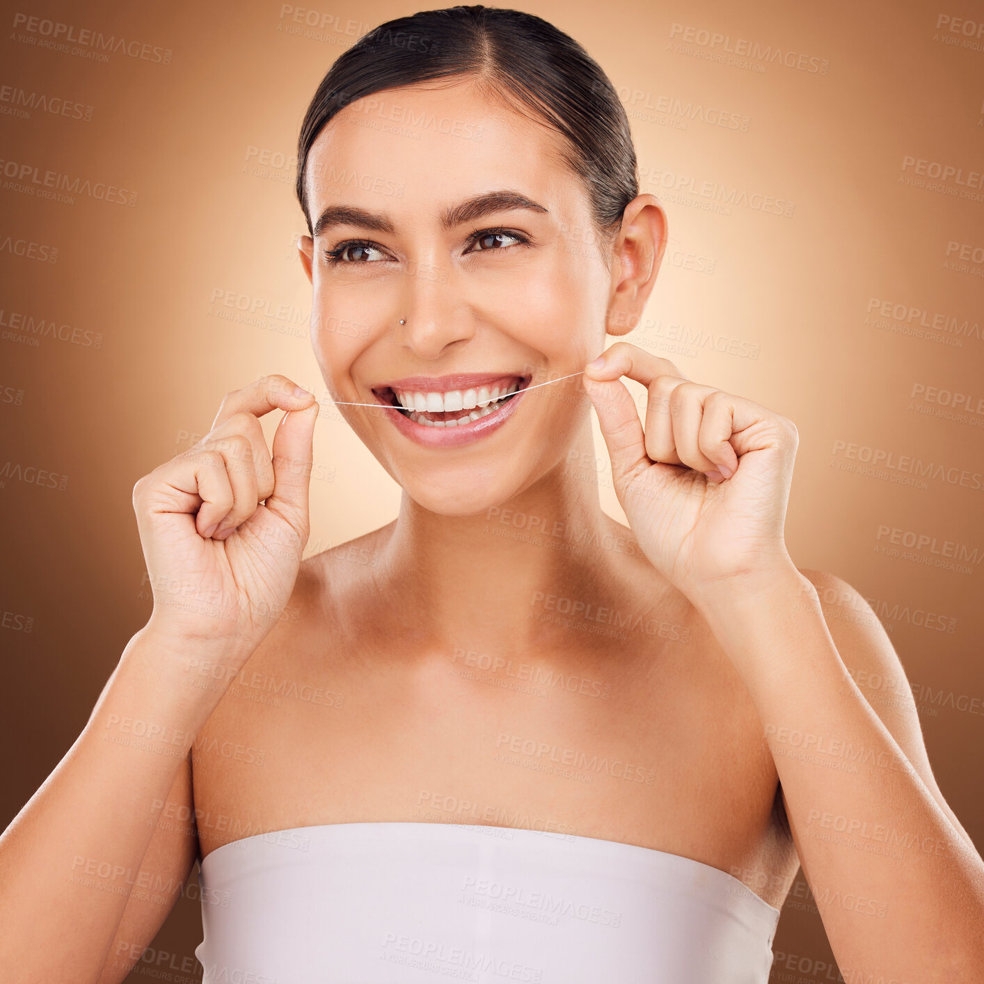 Buy stock photo Dental floss, face and happy woman cleaning teeth for oral hygiene routine, self care flossing or tooth healthcare. Mouth plaque treatment, gum care smile and studio female beauty on brown background