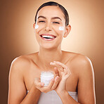 Portrait, skincare and cream with a model woman in studio on a brown background for beauty or hydration. Face, beauty and product with a happy young female holding a container to apply moisturizer