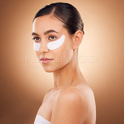 Buy stock photo Skincare, face or woman with eye patch for studio dermatology, cosmetic healthcare or beauty treatment. Spa care, facial collagen product or female model with hyaluronic acid mask on brown background