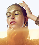 Gold, woman  and luxury beauty sparkle of a female with makeup and cosmetic glitter. Creative fashion, cosmetics and yellow face glow of a young person with shimmer and golden sparkles in a studio