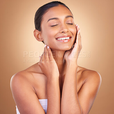 Buy stock photo Beauty, skincare and touch with indian woman in studio for happy, spa treatment and facial. Cosmetics, self care and glow with model on brown background for satisfaction, empowerment and confidence