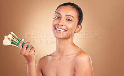 Buy stock photo Makeup brushes, smile and portrait of woman with natural beauty, wellness and happiness from cosmetics. Facial skin glow, happy and cosmetic face brush of a female model with self care in a studio