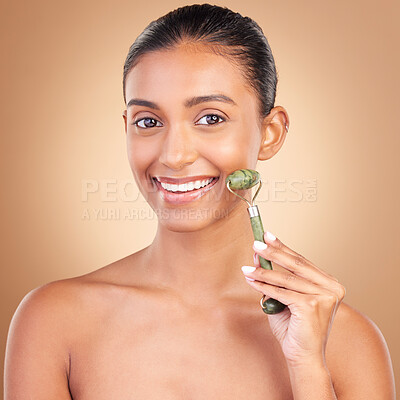 Buy stock photo Woman, beauty and derma roller with face, happiness with facial massage and skincare on studio background. Cosmetic tools, healthy skin glow and female smile in portrait, jade quartz and crystal