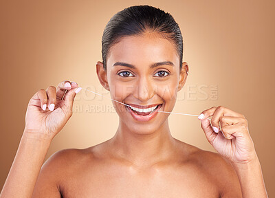 Floss, studio and portrait of a woman with healthcare, cleaning and dental health. Isolated, brown background and young female model with happiness from clean teeth and mouth wellness with a smile