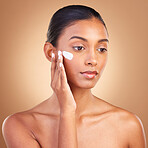 Skincare, sunscreen and natural beauty of a woman with cosmetic and spa cream. Isolated, studio background and young model with a glow from face cleaning, cosmetics and dermatology facial product