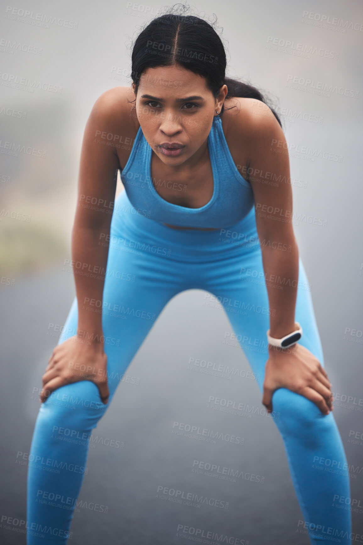 Buy stock photo Tired, fitness and breathing woman for outdoor cardio training, workout and sports running break in mist or fog. Focus, thinking and serious runner person with exercise goals and challenge in street