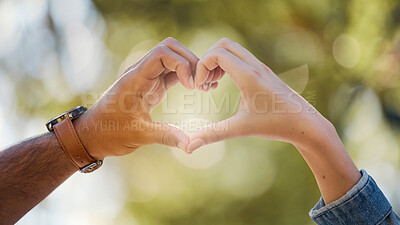 Buy stock photo Couple, heart and hands in park of love, date or marriage commitment together in garden. Closeup man, woman and finger shape of care in relationship, support and trust of hope, freedom and emoji sign