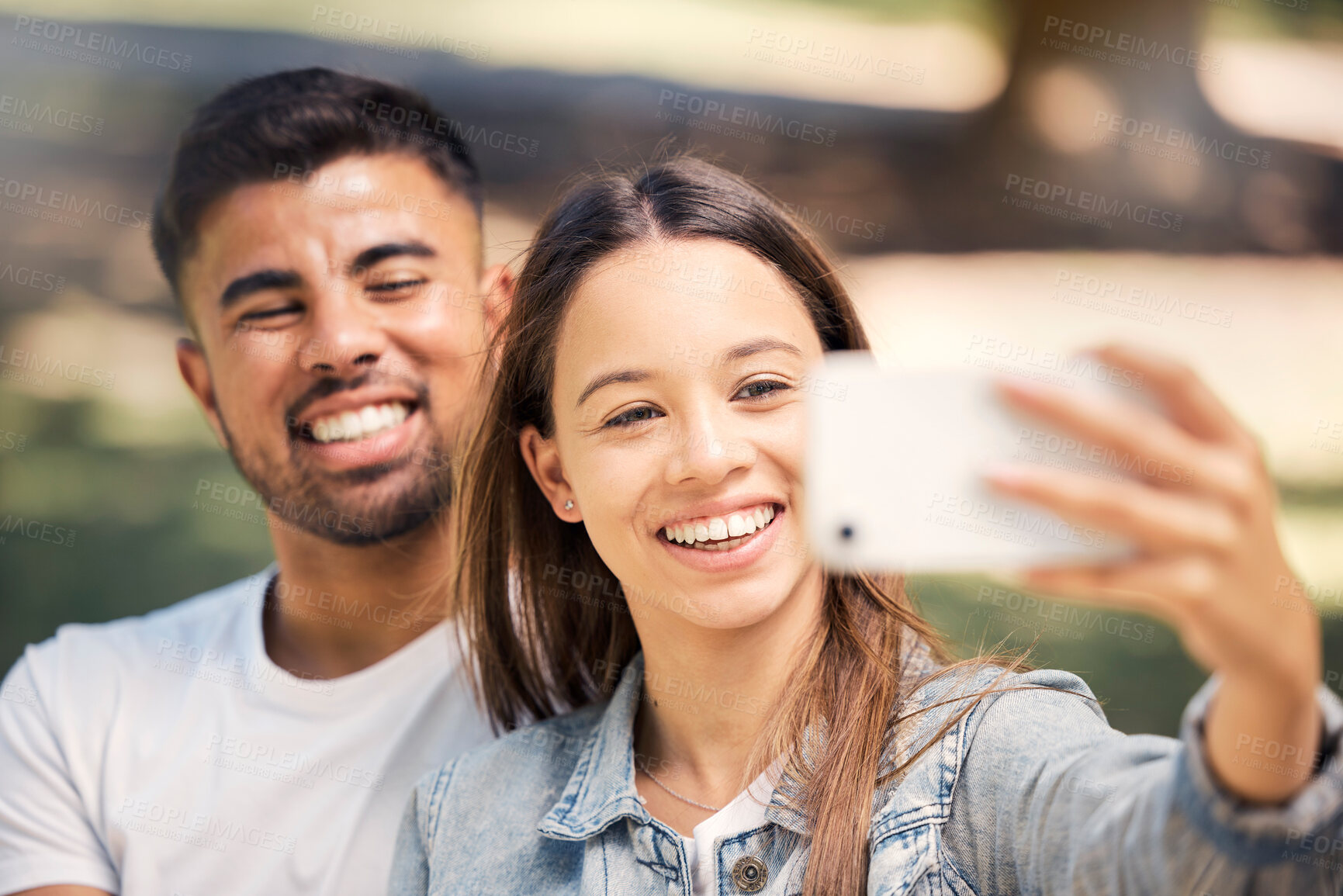 Buy stock photo Outdoor, couple and smile with a selfie for love, care and happiness together in summer. Young man and woman at nature park for a profile picture on a happy and romantic date or vacation to relax