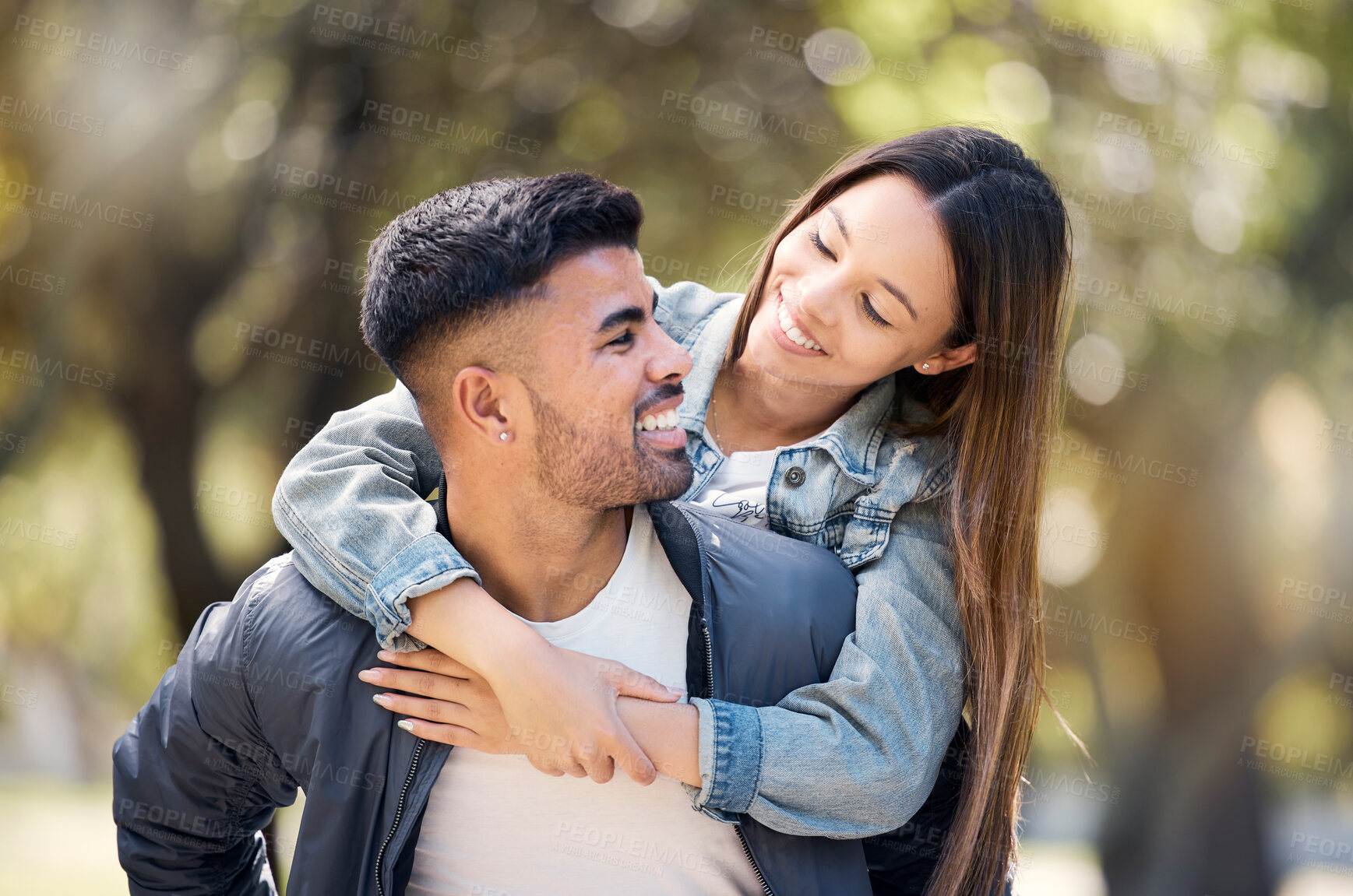 Buy stock photo Couple, smile and outdoor on piggyback for love, care and happiness together in summer. Young man and woman at nature park for a moment on a happy and romantic date or vacation to relax