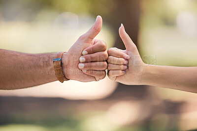 Buy stock photo Thumbs up, fist bump and people with outdoor teamwork, support and collaboration mission or agreement. Man, woman partner or couple of friends with like, deal and success hands sign, power and park
