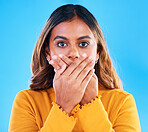Shock, surprise and portrait of a woman in a studio with a omg, wtf or wow face expression. Amazed, shocked and female model posing with a surprised reaction to news isolated by a blue background.