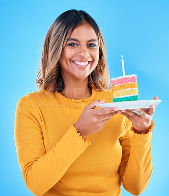 Buy stock photo Birthday cake, happy portrait and woman in studio, blue background or party celebration. Female model, rainbow dessert and candle of special event, sweets or smile to celebrate happiness, wish or fun