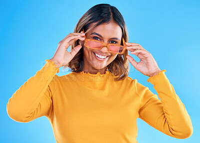 Buy stock photo Fashion, happy portrait or woman smiling with glasses, designer brand style or casual summer outfit. Gen z aesthetic, trendy sunglasses accessory or female face model on blue background studio