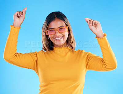 Buy stock photo Fashion portrait, dance and woman smiling with sunglasses, designer brand style or happy casual outfit. Gen z aesthetic, trendy glasses accessory or excited female celebrate on blue background studio
