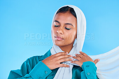 Buy stock photo Calm woman, muslim and beauty of hijab in studio, blue background or color backdrop. Young female model, islamic culture or scarf with eyes closed, peace or religion of arabic fashion for eid mubarak