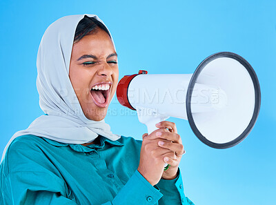 Buy stock photo Young woman, muslim and loudspeaker in studio for protest, human rights and scream by blue background. Girl, islam and megaphone for speech, justice and vote for freedom, mission and power politics