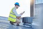 Engineering, digital tablet and engineer on a rooftop to inspect, fix or do maintenance on an outdoor fan. Technology, research and male industrial worker working with a mobile device on a building.