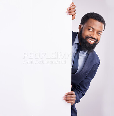 Buy stock photo Hiding, portrait and a black man standing by a wall isolated on a white background in a studio. Mockup, happy and an African corporate employee looking from a corner with space for advertising