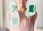 Woman, hands and housekeeping with detergent and sponge for spring cleaning, disinfection or dirt removal at home. Hand of female cleaner holding spray bottle and scrub with rubber gloves for hygiene