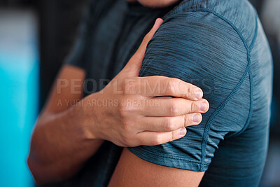 Buy stock photo Hand, shoulder and injury with a sports man holding a joint in pain while training in a gym for health. Fitness, accident or anatomy with a male athlete suffering from an injured body during exercise