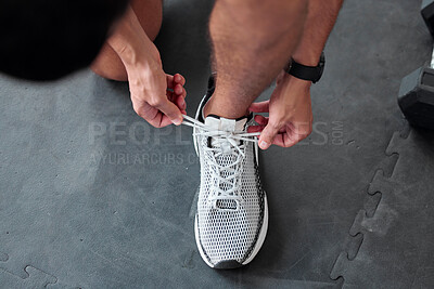 Buy stock photo Top view, hands and tie shoes in gym to start workout, training or exercise for sports. Athlete, man and tying laces on sneakers to prepare for running, cardio or exercising for health or fitness.