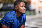 Fitness, break and man runner relax with music before training, running or morning cardio outdoors. Sports, pause and male athlete breathing, mindset and preparation for marathon practice workout run