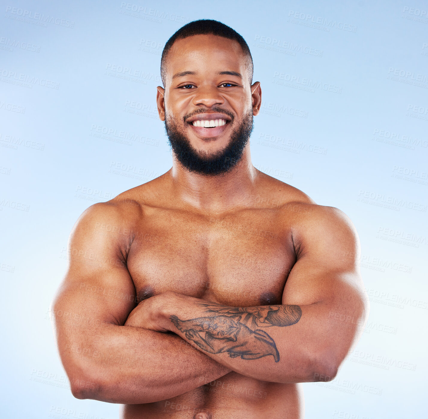 Buy stock photo Muscle, fit and portrait of a black man with arms crossed isolated on a blue background in studio. Happy, pride and African bodybuilder with fitness confidence, arm power and strength on a backdrop