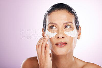 Buy stock photo Face, skincare and woman eye patches in studio isolated on a purple background. Thinking, dermatology and serious female model with facial mask or cosmetics pads for healthy skin, collagen and beauty