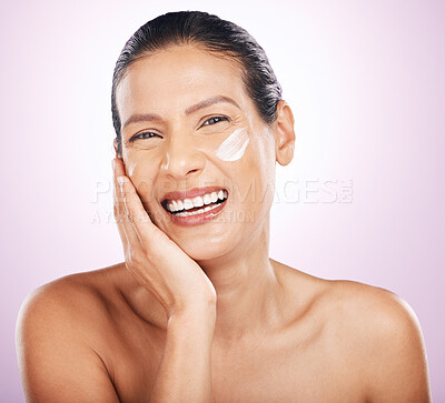Buy stock photo Face, cream and skincare of woman laughing in studio isolated on a purple background. Mature, portrait and happy female model with dermatology lotion, creme and moisturizer cosmetics for anti aging.