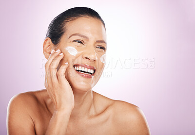 Buy stock photo Face smile, cream and skincare of woman in studio isolated on a purple background. Mature, thinking and happy female model with dermatology lotion, creme and moisturizer cosmetics for healthy skin.