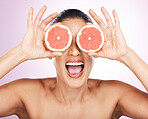 Face laughing, grapefruit and skincare of woman in studio isolated on a purple background. Natural cosmetics, food and happy mature female model with fruit for vitamin c, nutrition and healthy diet.