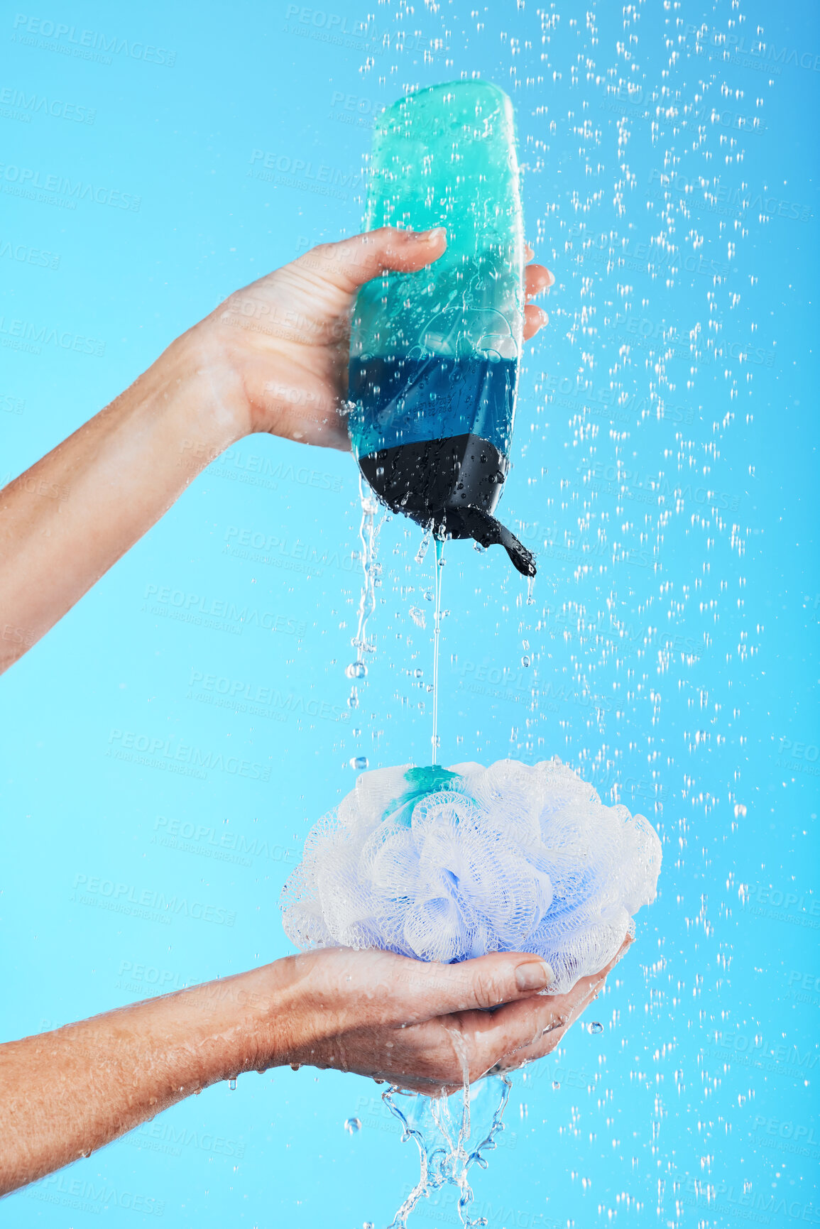 Buy stock photo Skincare, dermatology and hands with loofah and shower gel of person washing isolated in a studio blue background. Self care, beauty and person or model using soap and sponge for morning routine