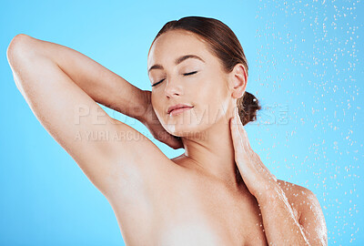 Buy stock photo Beauty, shower and `woman in a studio with a wellness, health and self care body routine. Skincare, water and female model washing while doing a luxury skin treatment isolated by a blue background.