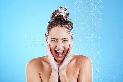 Buy stock photo Shower, beauty and excited portrait of woman in studio shout for wellness, body hygiene and cleaning hair. Skincare, bathroom and face of happy girl with water, shampoo and washing on blue background