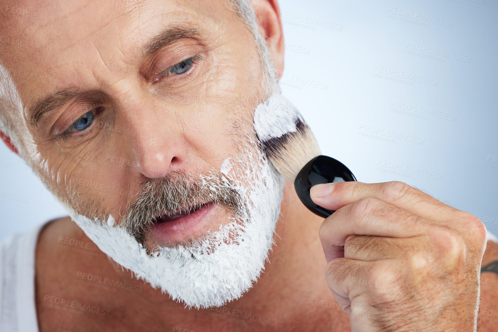 Buy stock photo Man, beard and shaving cream for grooming, skincare or hair removal against a studio background. Closeup of male face applying shave creme or foam product with brush for haircare or facial treatment