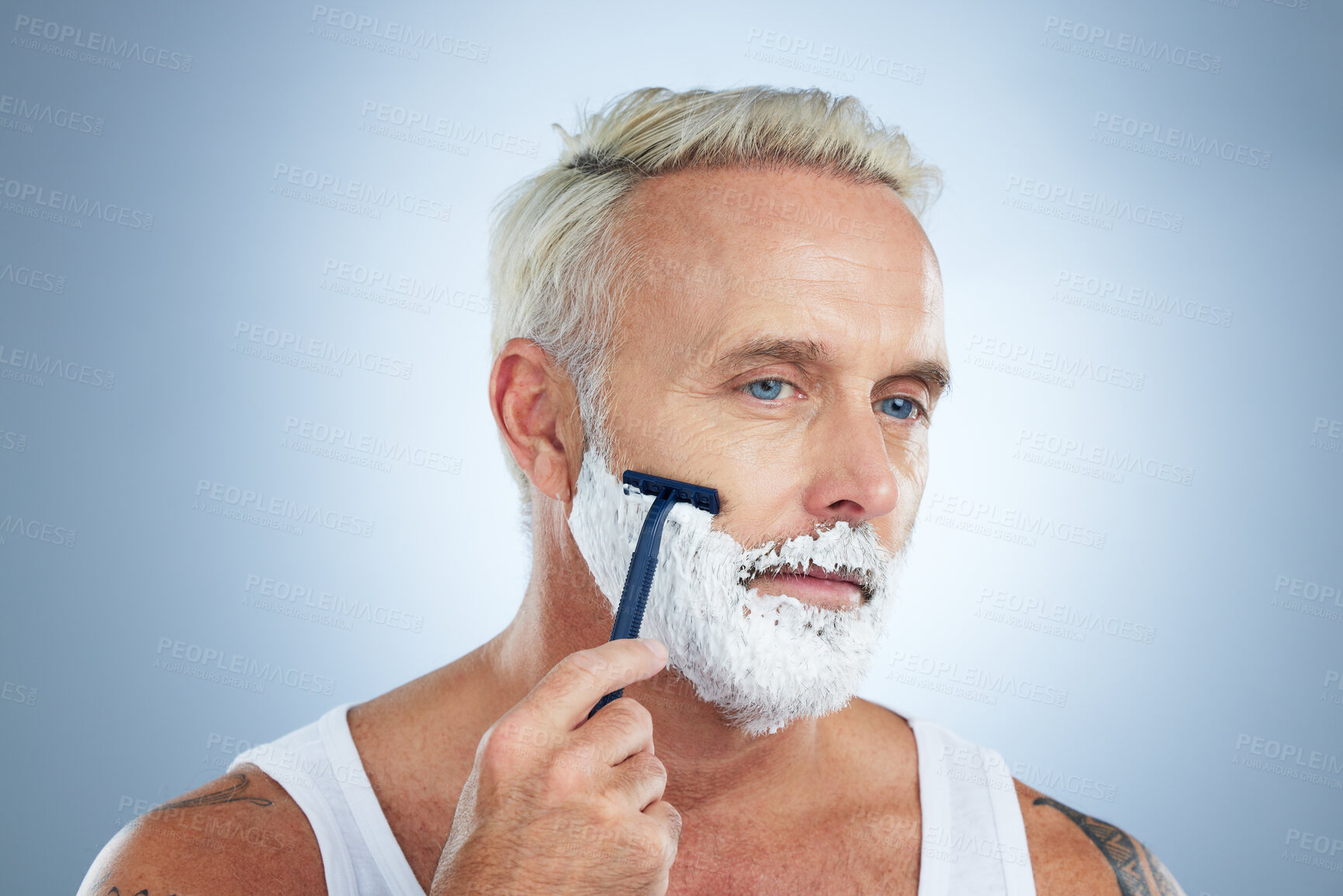 Buy stock photo Senior man, razor and shaving cream for beard grooming, skincare or hair removal against a studio background. Mature male face with shaver, creme or foam product for clean hygiene or facial treatment