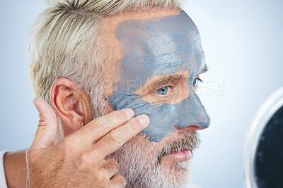 Buy stock photo Mask, skincare and facial with man in studio for cleansing, detox and spa treatment. Cosmetics, beauty and dermatology with senior model on gray background for anti aging, product and natural